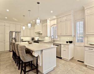 Beautiful Ornate Corbels adorn this large island incorporated into this Custom Kitchen Design in Aurora